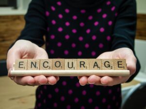 Encourage spelled out in scrabble tiles